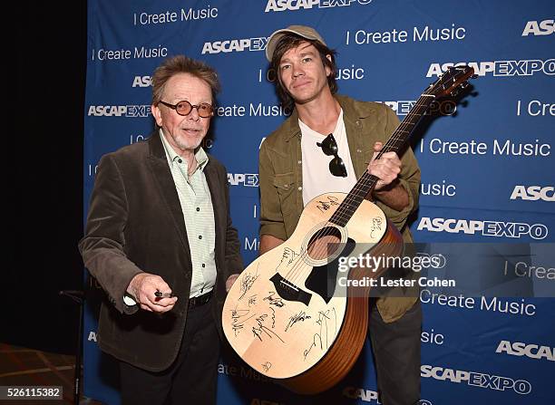 President/Chairman Paul Williams and singer-songwriter Nate Ruess pose with a #StandWithSongwriters guitar, which will be presented in May to members...
