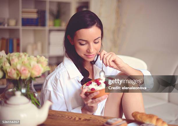 young brunette woman in home interior. - cottage cheese stock pictures, royalty-free photos & images