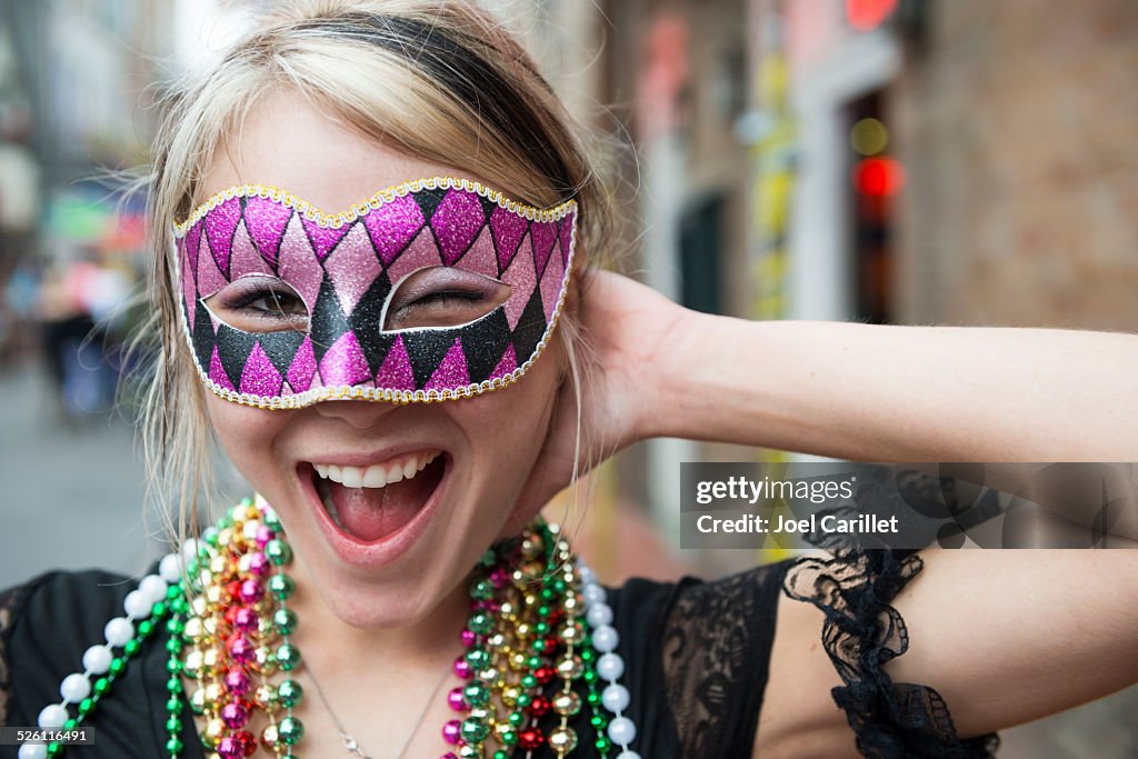 Fun-loving young woman at Mardi Gras in New Orleans Louisiana