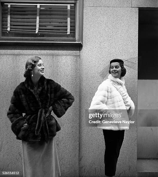 Two women modeling furs for Harper's Bazaar magazine