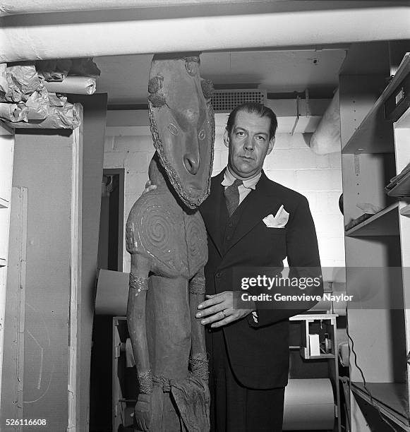 Art expert and museum director Rene d'Harnoncourt with a New Guinean sculpture.