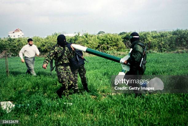 This handout photo from the Palestinian Islamic Resistance Movement group shows armed Hamas activists to prepare what appears to be homemade Qassam...