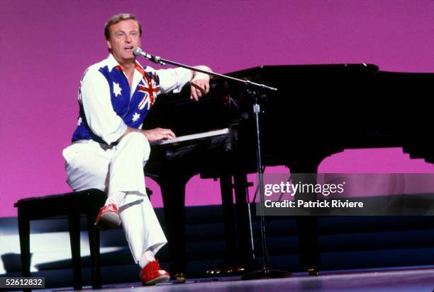 Australian singer Peter Allen sings at the State Sport Centre in Homebush March 12, 1985 in Sydney, Australia. The pageant was telecast was live and...