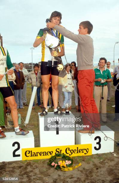 Cyclist Phil Anderson presents the cup to the winner of the Clarence St Cyclery Cup in 1983, in Sydney, Australia.