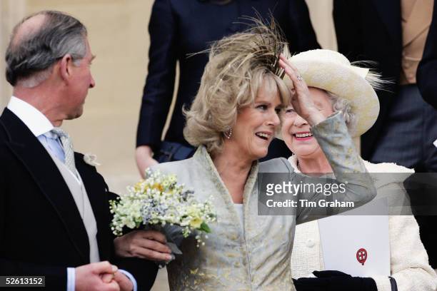 The Prince of Wales, Prince Charles, and The Duchess Of Cornwall, Camilla Parker Bowles in silk dress by Robinson Valentine and clutching her...