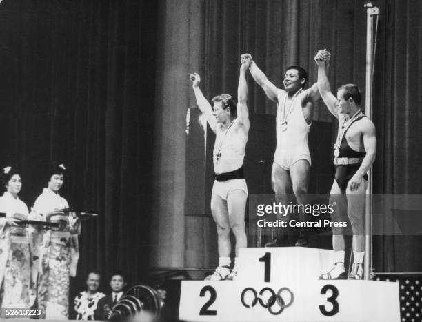 The three winners of the Featherweight Weightlifting event at the Tokyo Olympics, 14th October 1964. From left to right, they are Isaac Berger of the...