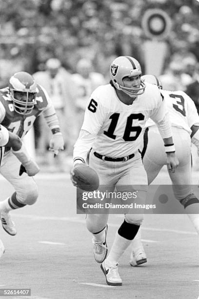 Quarterback Jim Plunkett of the Oakland Raiders prepares to hand the ball off during a game on November 23, 1980 against the Philadelphia Eagles at...