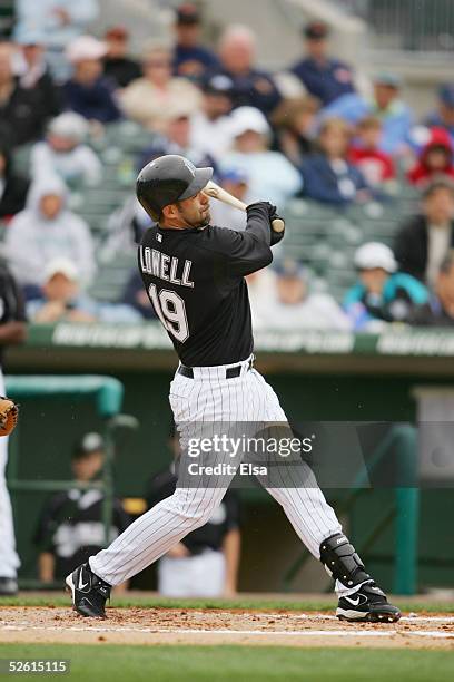 Infielder Mike Lowell of the Florida Marlins bats against the Baltimore Orioles during their spring training game on March 3, 2005 at Roger Dean...