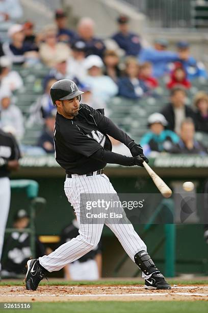 Infielder Mike Lowell of the Florida Marlins bats against the Baltimore Orioles during their spring training game on March 3, 2005 at Roger Dean...