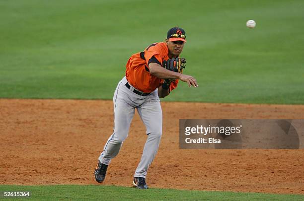 Infielder Melvin Mora of the Baltimore Orioles fields and throws a ball against the Florida Marlins during a spring training game on March 3, 2005 at...