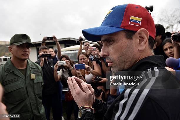 Governor of Miranda state Henrique Capriles talks with a military officer asking permision to visit jailed opposition Leader Leopoldo Lopez on his...