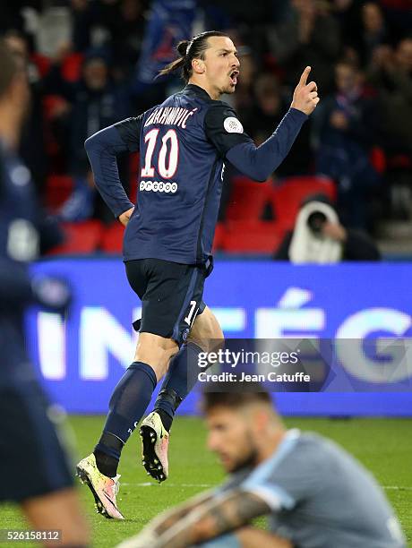 Zlatan Ibrahimovic of PSG celebrates his second goal while goalkeeper of Rennes Benoit Costil looks on during the French Ligue 1 match between Paris...