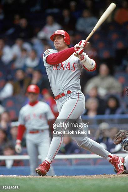 Jose Canseco of the Texas Rangers hits a home run during the season game at Tiger Stadium in Detroit, Michigan on May 4, 1994. Jose Canseco played...