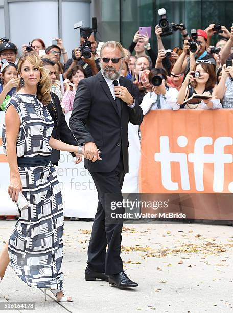 Kevin Costner and wife Christine Baumgartner arrives at the 'Black and White' premiere during the 2014 Toronto International Film Festival at Roy...