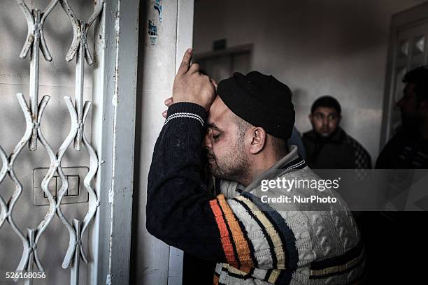 Palestinian medics wheel the body of Ibrahim Suleiman Mansour dead by Israeli security forces at a hospital in Gaza City on February 13, 2014. A...