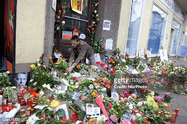 An image of David Bowie is on in Berlin, Germany in front of his former home between flowers. The artist died on Sunday surprisingly with 69 years of...