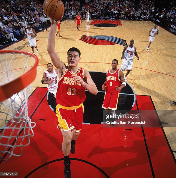 Yao Ming of the Houston Rockets takes the ball to the basket during a game against the Portland Trail Blazers at The Rose Garden on March 30, 2005 in...