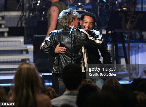 Singers Rod Stewart and John Legend hug after their performance at "Save The Music: A Concert To Benefit The VH1 Save The Music Foundation" at the...