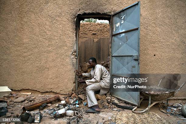 Ousmane Tour��??����, a Songhai man from Gao, tries to salvage what remains of his father��????s shop, in the market area of Kidal, Mali on 24 August...