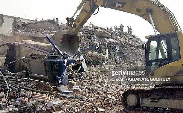 Steam shovel removes debris of a collapsed factory in Palash Bari, some 30 kilometres northwest of Dhaka, 12 April 2005. Rescue workers warned that...