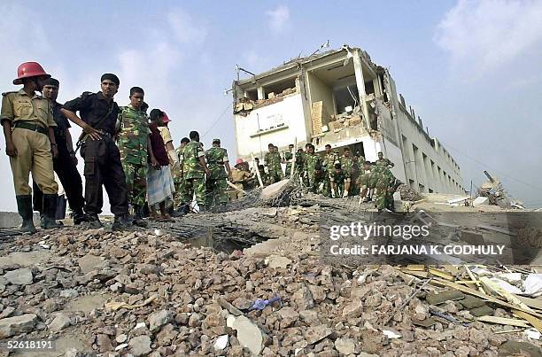 Bangladeshi rescue workers and soldiers search for survivors through the debris of a collapsed factory in Palash Bari, some 30 kilometres northwest...