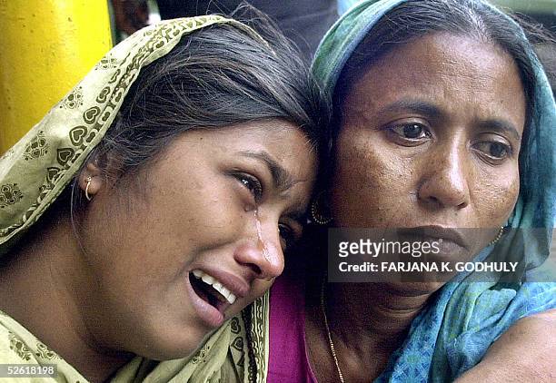 Relatives of trapped Bangladeshi factory workers weep as they wait for news of their missing loved one after a factory collapsed in Palash Bari, some...