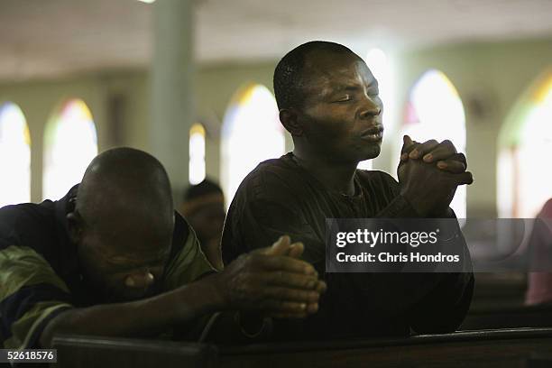 Nigerian Catholic worshipper pray during morning mass April 12, 2005 in Kano, Nigeria. Kano is part of Nigeria's primarily Muslim north, but devoted...