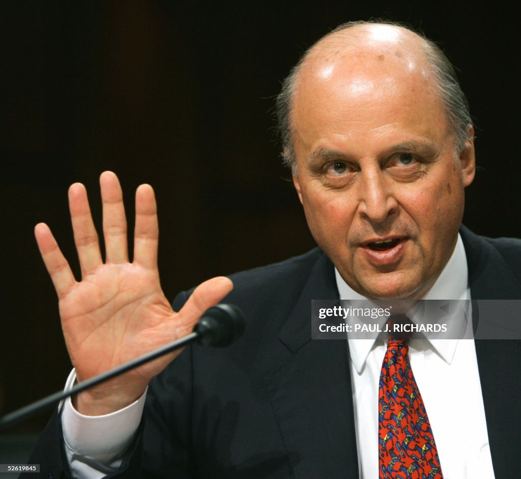 John Negroponte holds up 5-fingers when