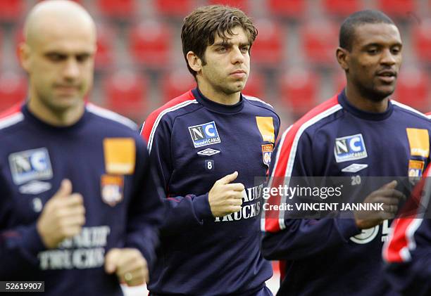 Olympique Lyonnais midfielder Juninho Pernambucano jogs with teammates and Eric Abidal, during a training session a day prior their UEFA Champions...