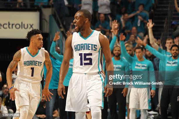 Kemba Walker and Courtney Lee of the Charlotte Hornets reacts during the game against the Miami Heat in Game Six of the Eastern Conference...