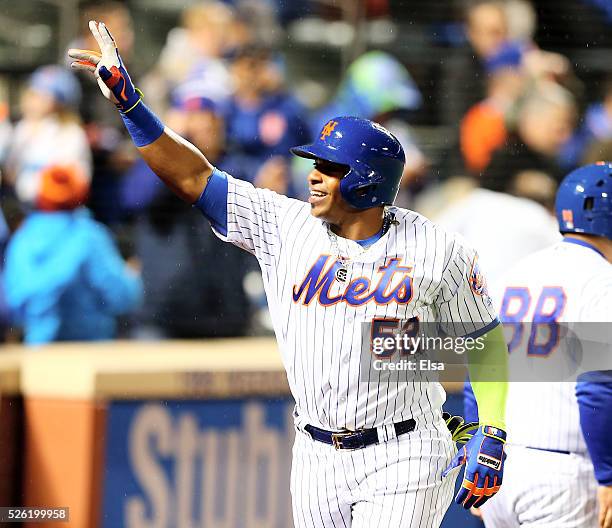 Yoenis Cespedes of the New York Mets celebrates as he heads for the dugout after he hit grand slam in the third inning against the San Francisco...
