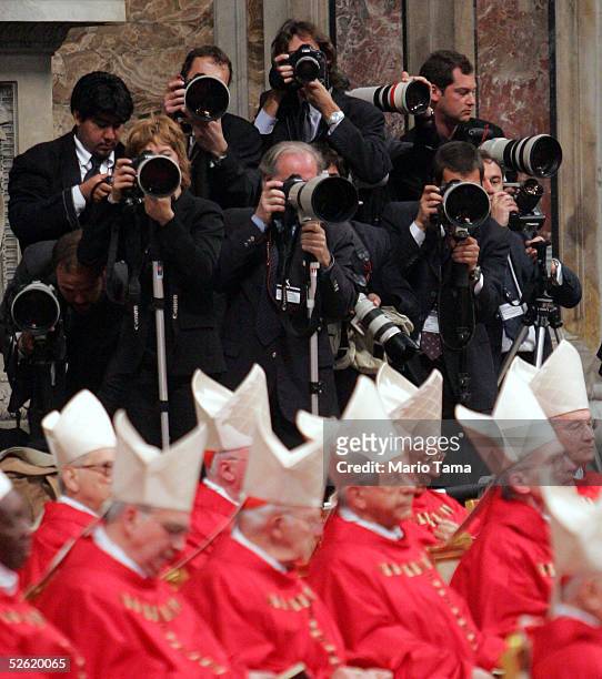 Photographers train their lenses on the Cardinals who are present at a Mass presided over by Brazilian Cardinal Eugenio Sales de Araujo Apri 12, 2005...