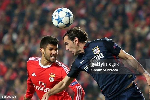 Atletico Madrid's defender Diego Godn heads the ball with Benfica's defender Lisandro Lopez during the UEFA Champions League Group C football match...