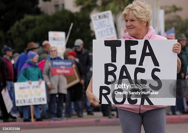 Protesters display signs during a TEA Party rally in San Diego, California. The rally featured speakers opposed many forms of government spending,...