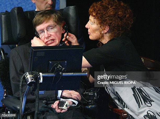 British astrophysicist Stephen Hawking's wife, Elaine, adjusts the earphones to her husband after his conference to open the XXV Prince of Asturias...