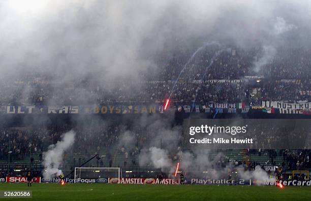 Inter fans shower the pitch with flares during the UEFA Champions League quarter-final second leg between AC Milan and Inter Milan at the San Siro...