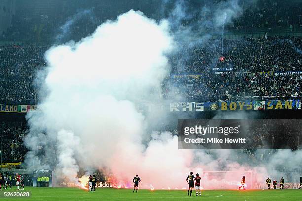 Inter fans shower the pitch with flares during the UEFA Champions League quarter-final second leg between AC Milan and Inter Milan at the San Siro...