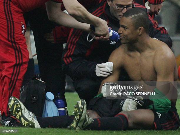 Milan's Brazilian goalkeeper Nelson Dida is treated by doctors after he was injured by fireworks during Inter Milan's-AC Milan's second leg Champions...