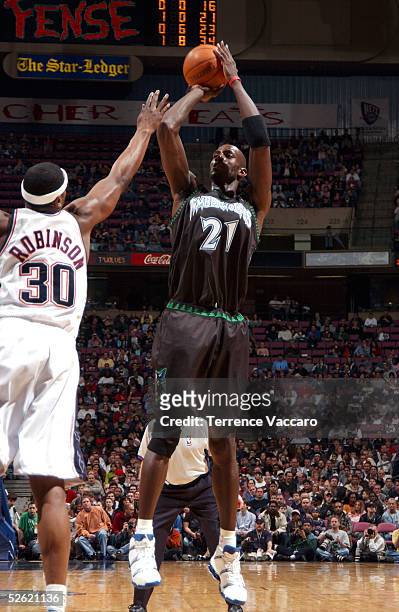 Kevin Garnett of the Minnesota Timberwolves shoots over Clifford Robinson of the New Jersey Nets during the game at Continental Airlines Arena on...