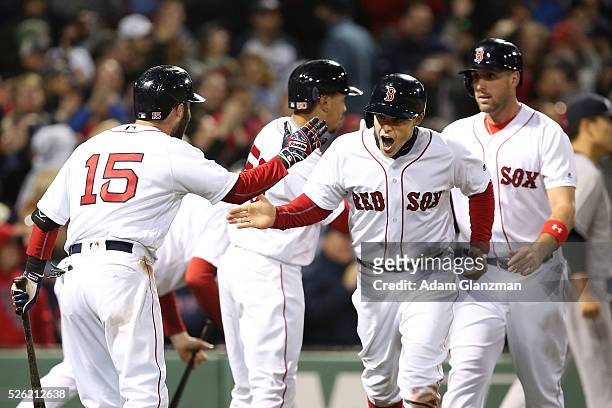 Brock Holt of the Boston Red Sox returns to the dugout after scoring in the seventh inning in the game against the New York Yankees at Fenway Park on...