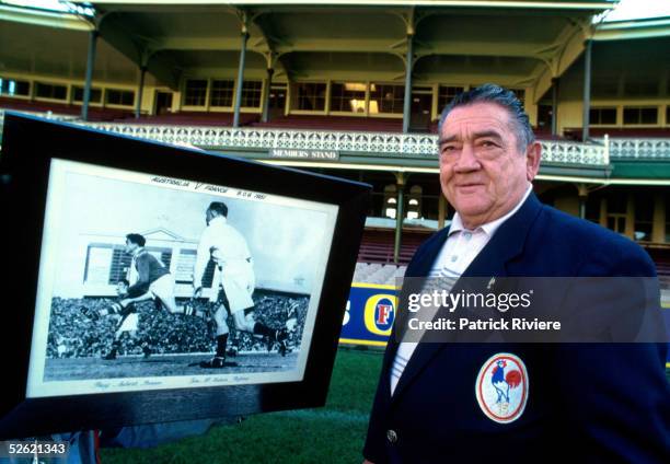 Former French rugby League player Puig-Aubert of his real name Aubert Puig, poses in front of a large print showing him playing against Australia in...