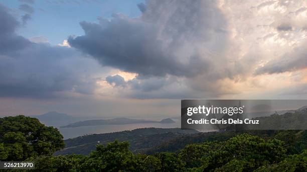 taal volcano with rain clouds - tagaytay stock pictures, royalty-free photos & images