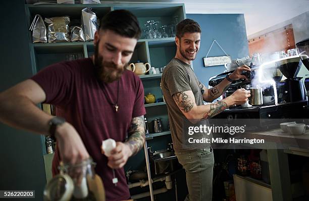 young tattooed males working in cafe - facial hair stock pictures, royalty-free photos & images