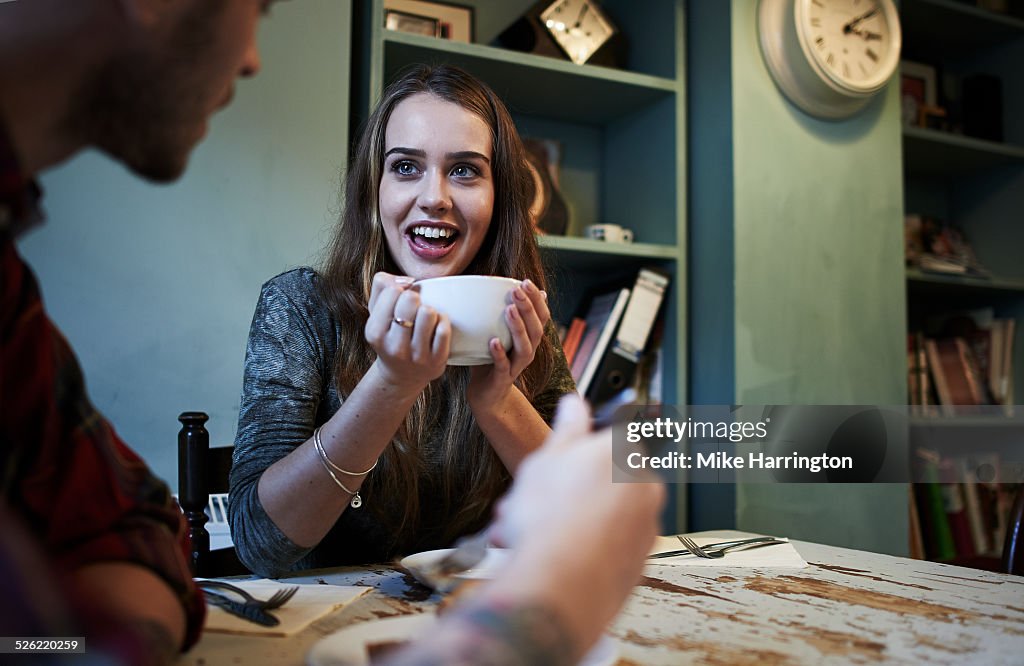 Young female holding mug and smiling