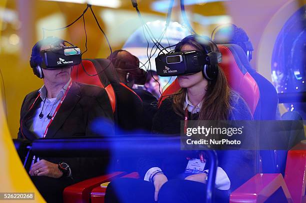 Congress attendants reacting to VK Telecom virtual 360 glasses , during the last day of Mobile World Congress in Barcelona, 24th of February, 2016.