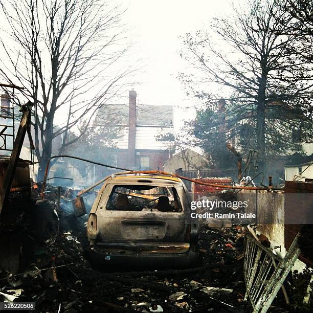 Smoke smolders after a fire that destroyed dozens of homes and vehicles during the Hurricane Sandy in Breezy Point section of Queens, New York,...