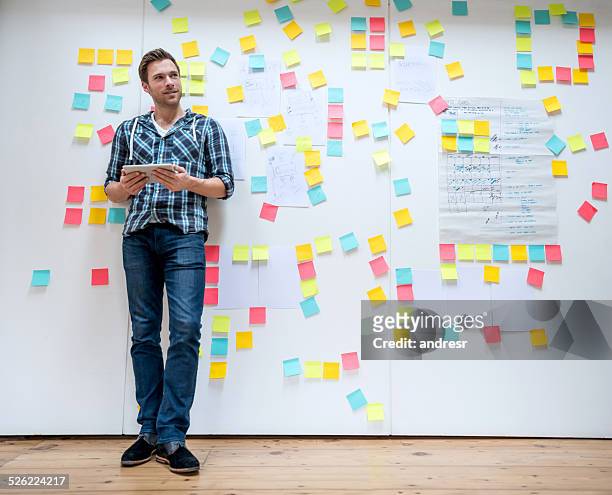 business man brainstorming - brainstorming wall stock pictures, royalty-free photos & images