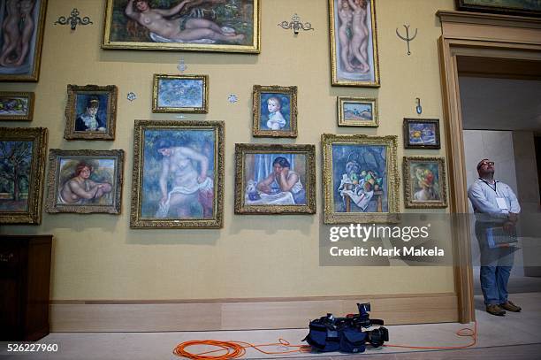 May 16, 2012 - Philadelphia, PA, U.S - An NBC television journalist lays his camera in front of impressionist paintings from the Barnes Foundation...