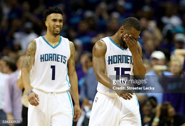 Teammates Kemba Walker and Courtney Lee of the Charlotte Hornets react after a call against the Miami Heat during game six of the Eastern Conference...