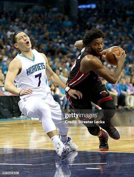 Justise Winslow of the Miami Heat drives to the basket against Jeremy Lin of the Charlotte Hornets during game six of the Eastern Conference...